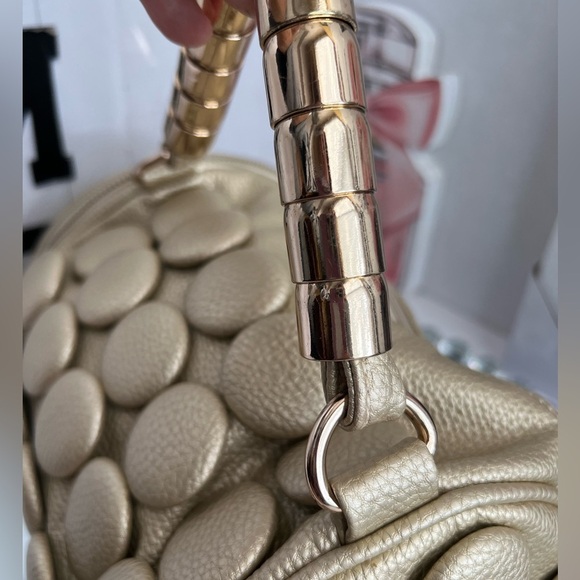 unique design with embossed circular details and a structured, metallic handle. - Picture 9 of 12